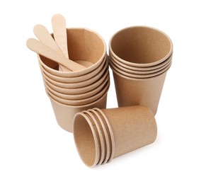 Photo of Set of disposable cups and wooden sticks isolated on white