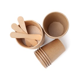 Photo of Set of disposable cups and wooden sticks isolated on white