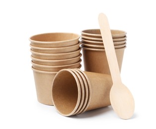 Photo of Set of disposable cups and wooden spoon isolated on white
