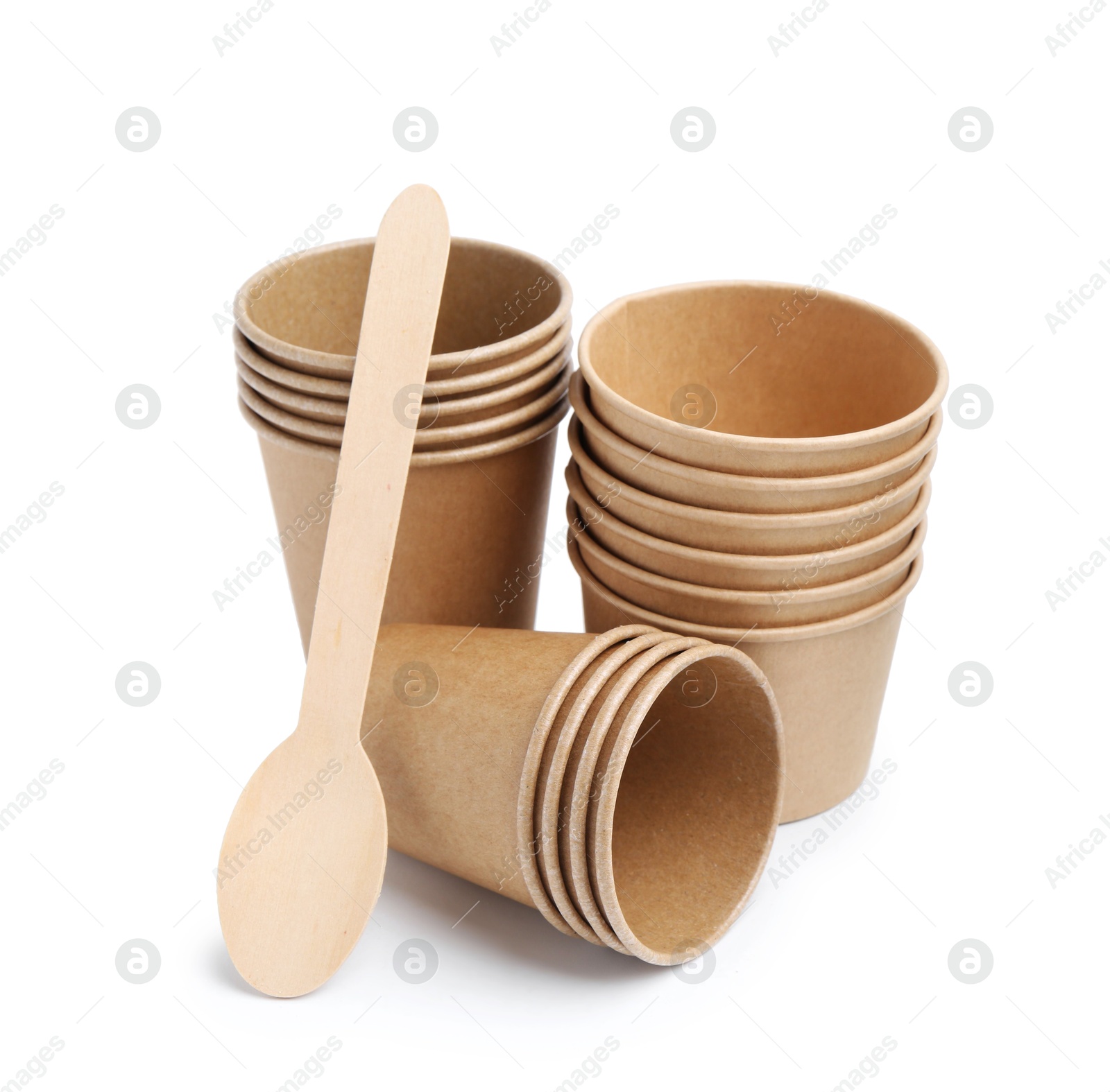 Photo of Set of disposable cups and wooden spoon isolated on white