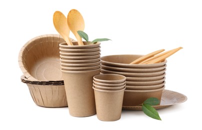 Photo of Set of disposable tableware and leaves isolated on white