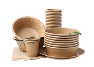 Photo of Set of disposable tableware and leaves isolated on white