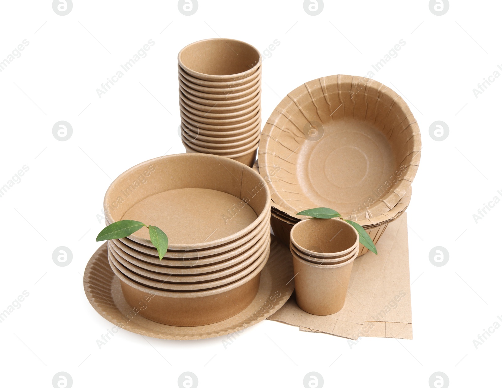 Photo of Set of disposable tableware and leaves isolated on white