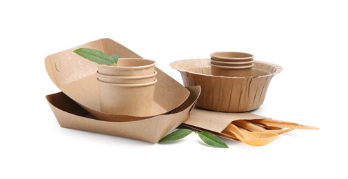 Photo of Set of disposable tableware and leaves isolated on white