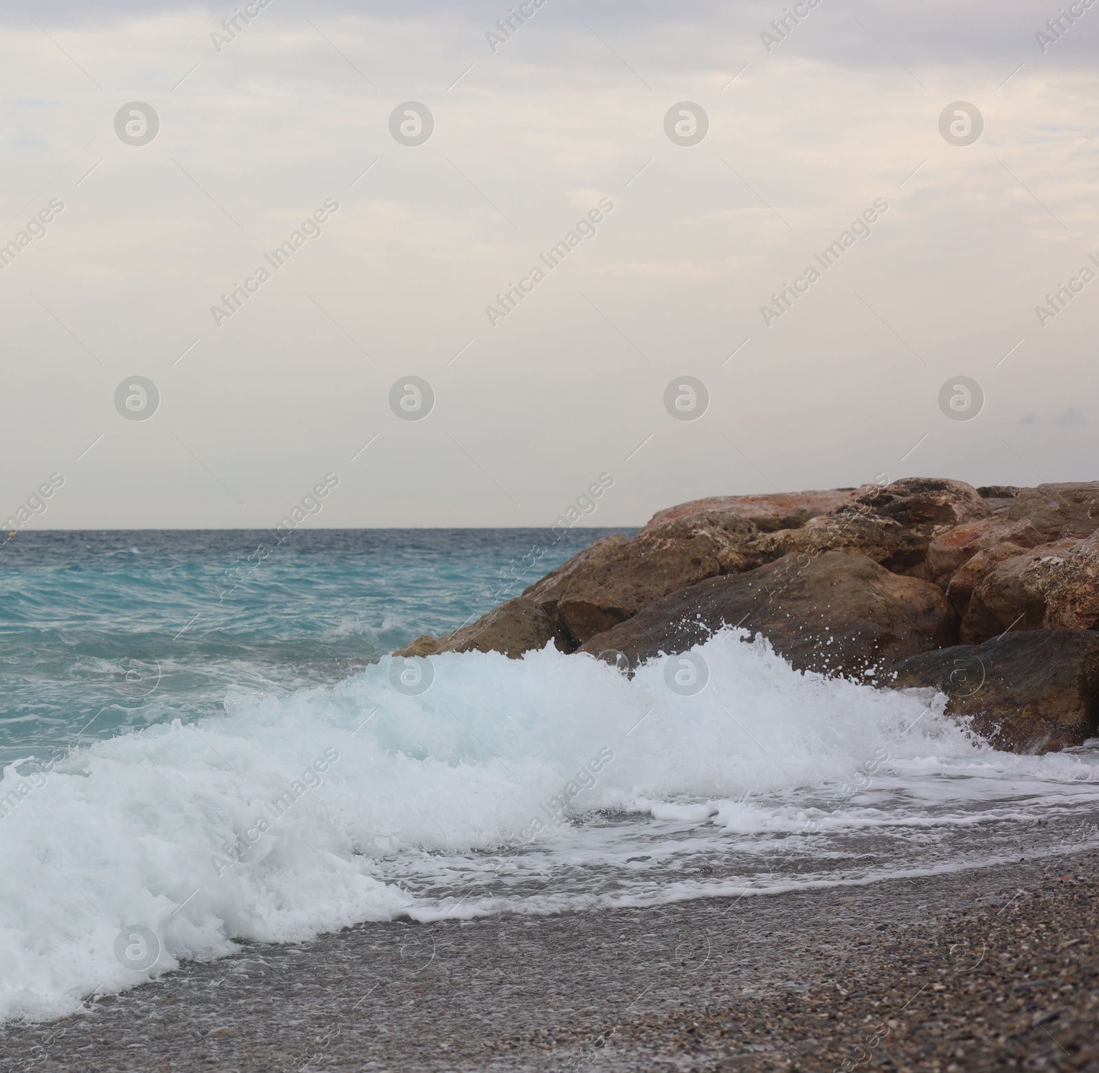 Photo of Beautiful view of wavy sea and pebbles on beach