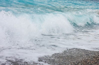 Photo of Beautiful view of wavy sea and pebbles on beach