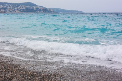 Photo of Beautiful view of wavy sea and pebbles on beach