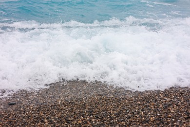 Photo of Beautiful view of wavy sea and pebbles on beach