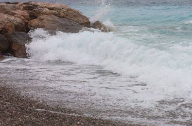 Photo of Beautiful view of wavy sea and pebbles on beach