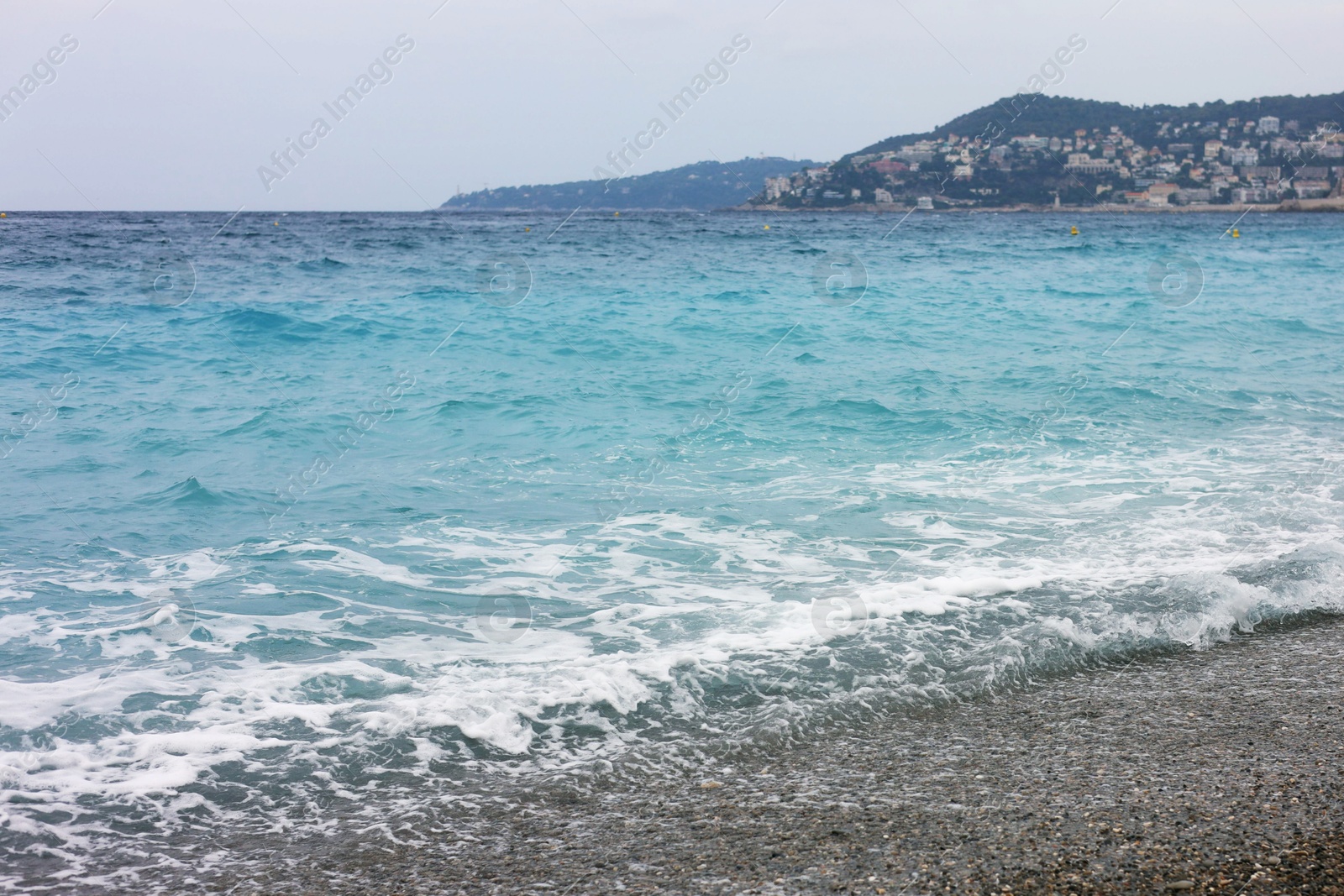 Photo of Beautiful view of wavy sea and pebbles on beach
