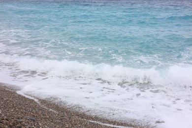Photo of Beautiful view of wavy sea and pebbles on beach