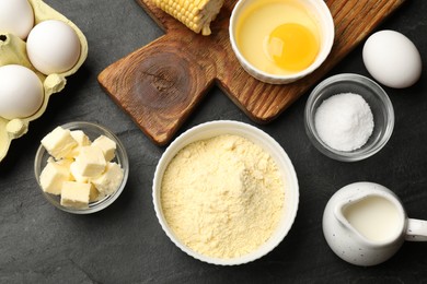 Photo of Cornbread preparation. Different ingredients on black textured table, flat lay