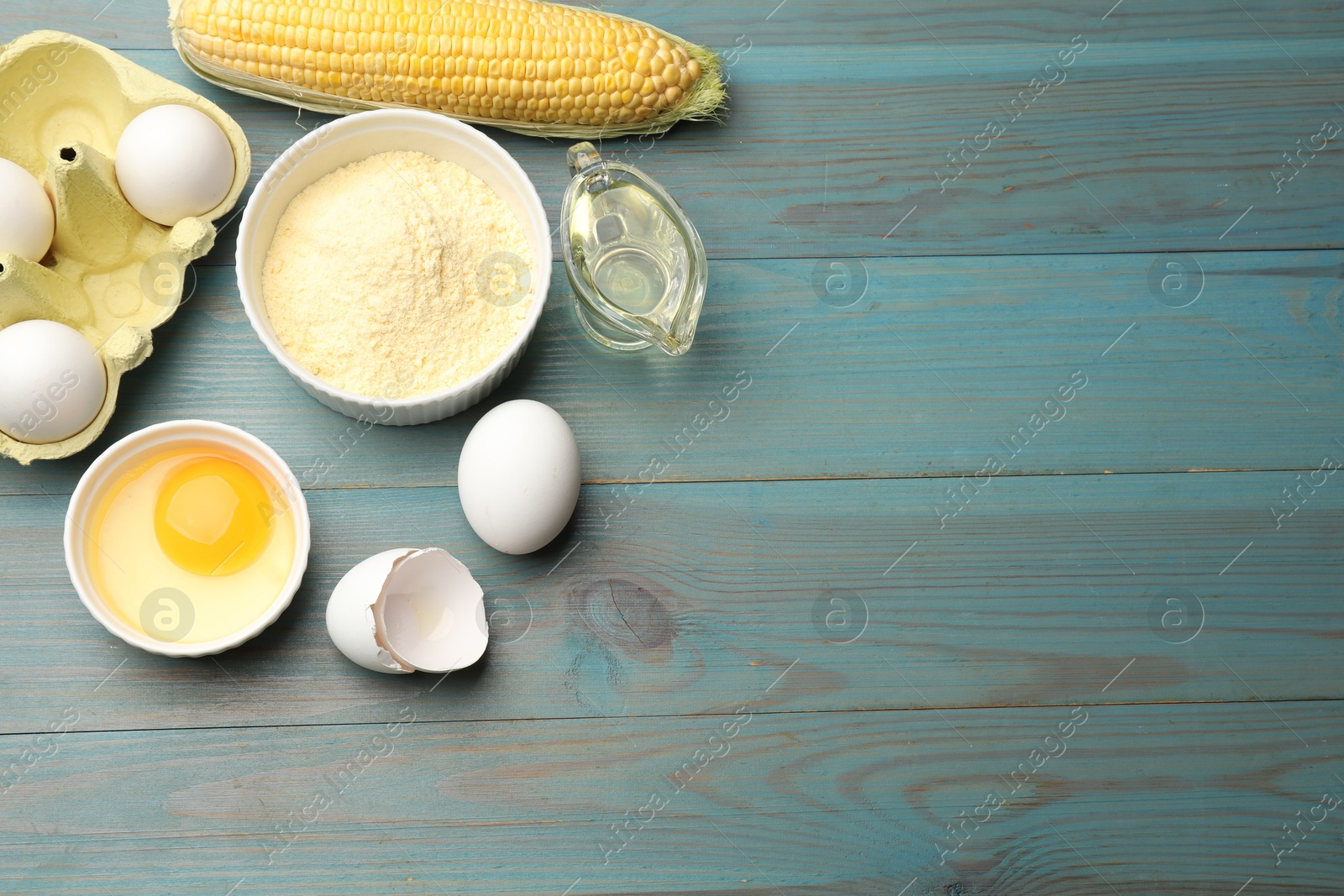 Cornbread preparation. Different ingredients on light blue wooden table, flat lay. Space for text Photo of Cornbread preparation. Different ingredients on light blue wooden table, flat lay. Space for text