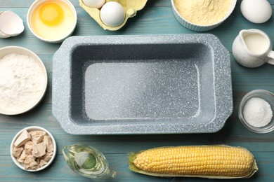 Photo of Cornbread preparation. Baking dish surrounded by different ingredients on light blue wooden table, flat lay