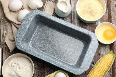 Photo of Making cornbread. Baking dish, different ingredients and whisk on wooden table, flat lay