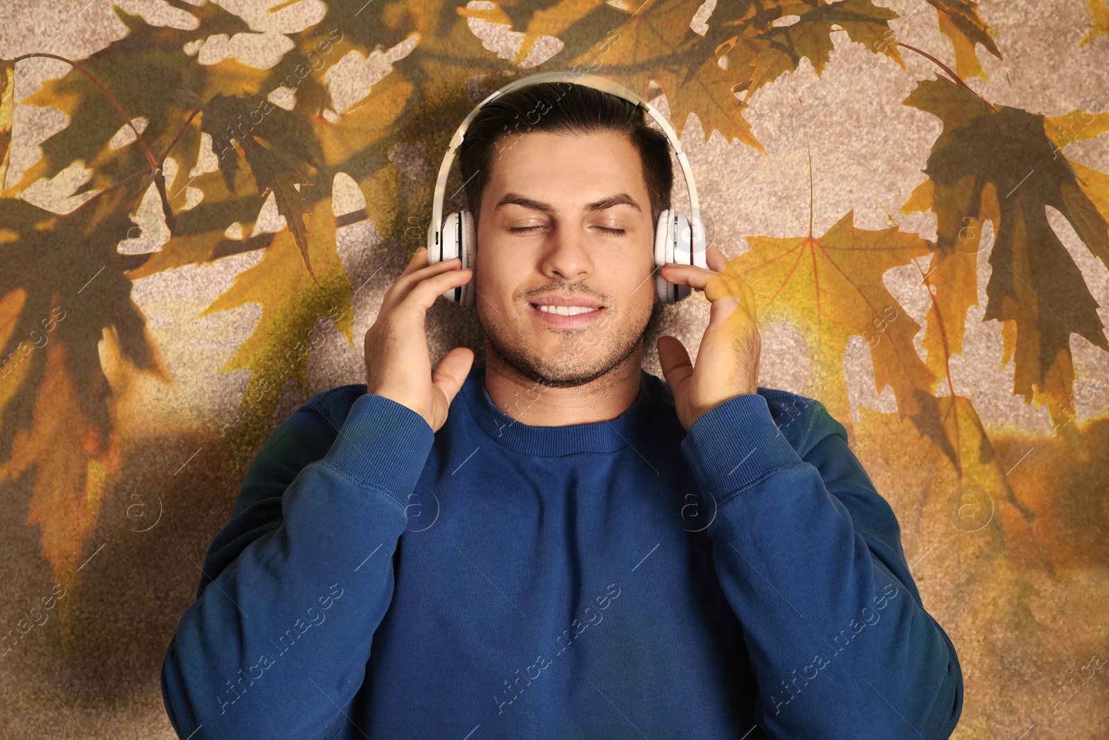 Image of Happy man listening to sounds of nature which making him feel calm. Double exposure of carpet and tree branch