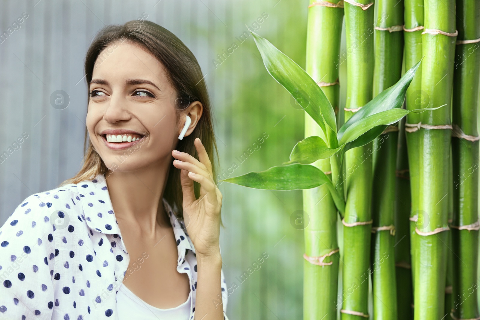 Image of Happy woman listening to sounds of nature which making her feel comfort. Double exposure with bamboo plants