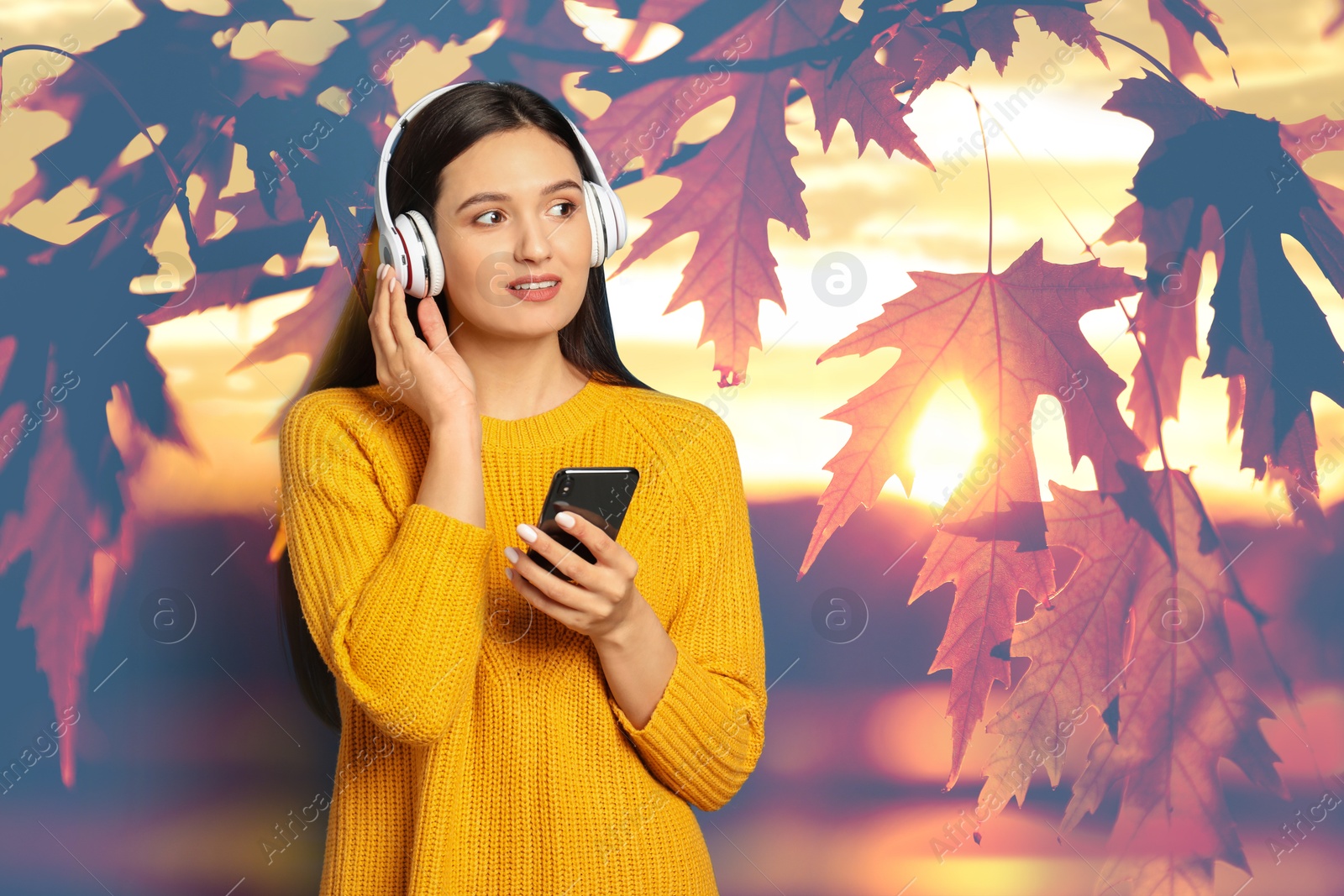 Image of Woman listening to sounds of nature which making her feel calm. Tree branch with leaves on background
