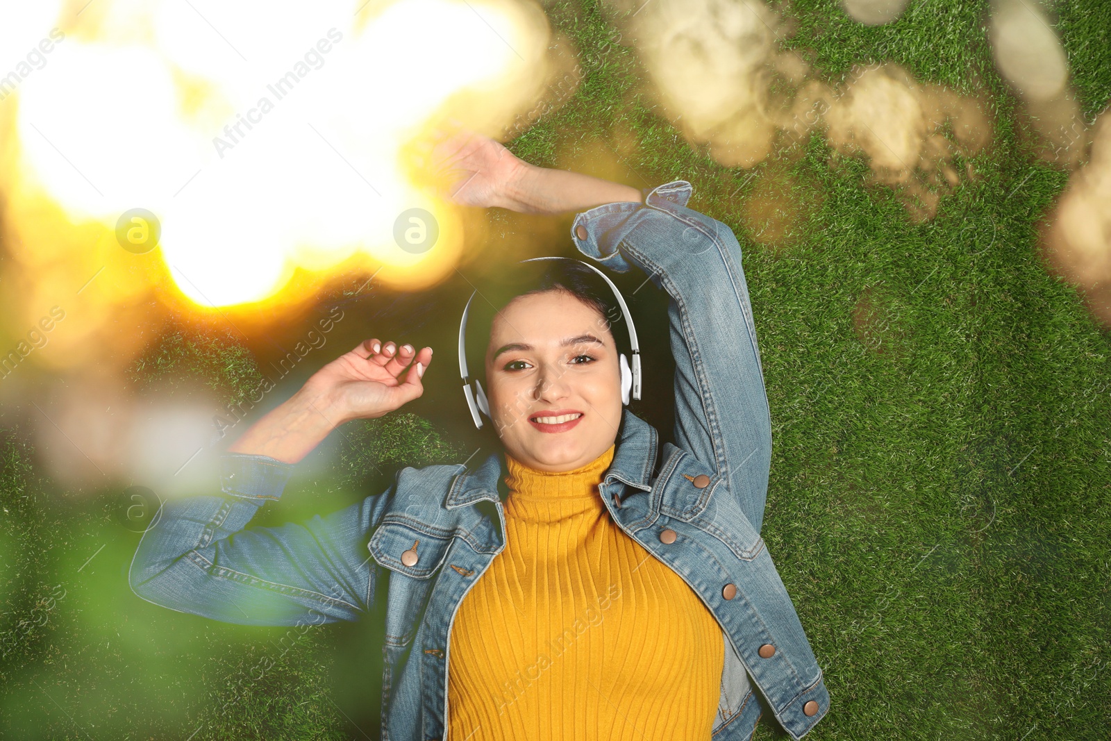 Image of Happy woman listening to sounds of nature which making her feel calm. Bokeh effect