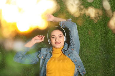 Image of Happy woman listening to sounds of nature which making her feel calm. Bokeh effect