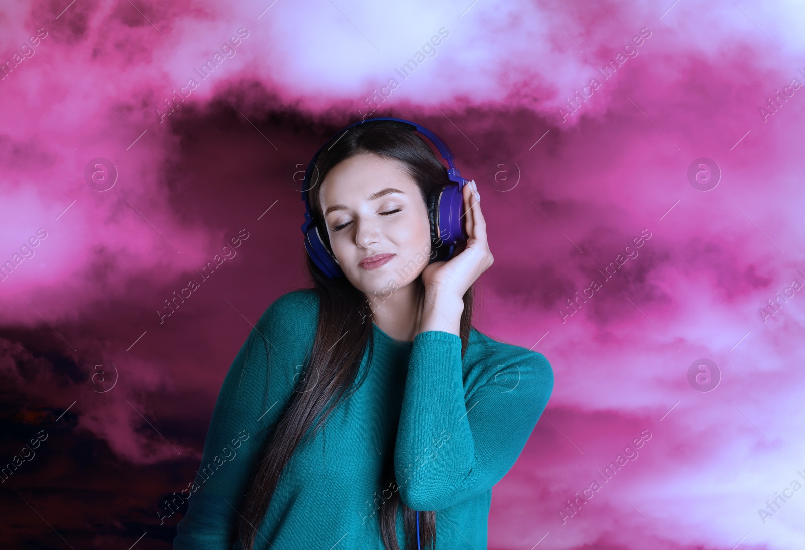 Image of Woman listening to sounds of nature which making her feel calm. Double exposure with clouds