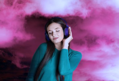 Image of Woman listening to sounds of nature which making her feel calm. Double exposure with clouds