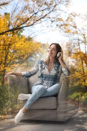 Image of Woman listening to sounds of nature which making her feel calm. Double exposure of room and landscape
