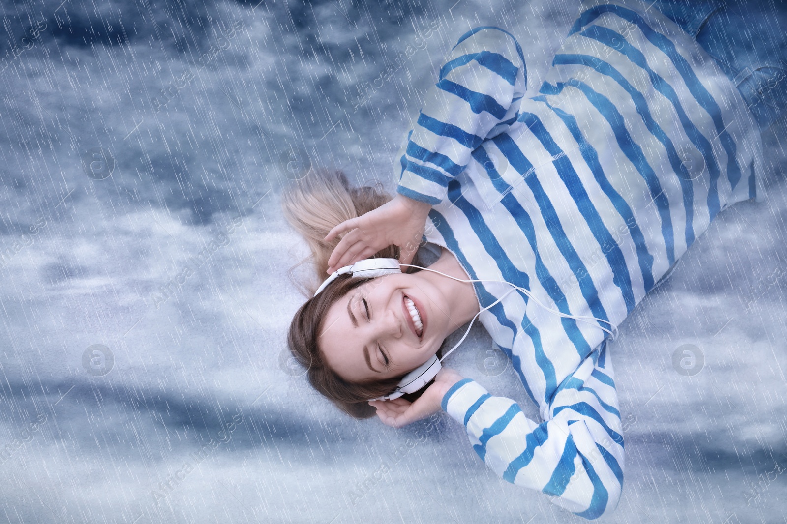 Image of Happy woman listening to sounds of nature which making her feel calm. Double exposure with sky