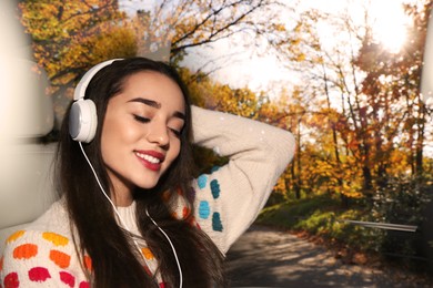 Image of Happy woman listening to sounds of nature which making her feel calm. Double exposure with autumn landscape