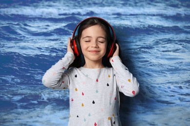 Image of Happy little girl listening to sounds of nature which making her feel calm. Double exposure with sea waves
