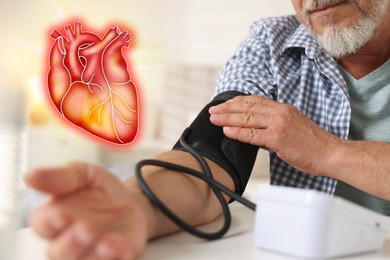 Image of Cardiology. Senior man measuring blood pressure at table indoors, closeup. Illustration of heart