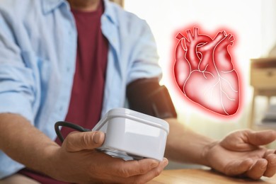 Image of Cardiology. Senior man measuring blood pressure at table indoors, closeup. Illustration of heart
