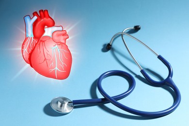 Image of Cardiology. Stethoscope and illustration of heart on light blue background