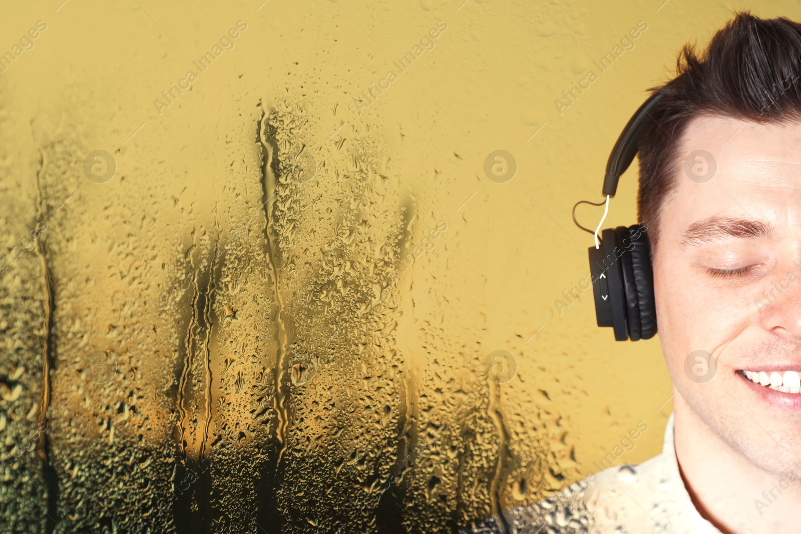Image of Happy man listening to sounds of nature which making him feel calm. Double exposure with wet window on rainy day