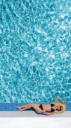 Image of Beautiful young woman lying near swimming pool, top view
