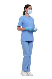 Photo of Nurse in uniform, medical mask and protective gloves with tray on white background