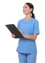 Photo of Smiling nurse in uniform writing on clipboard against white background