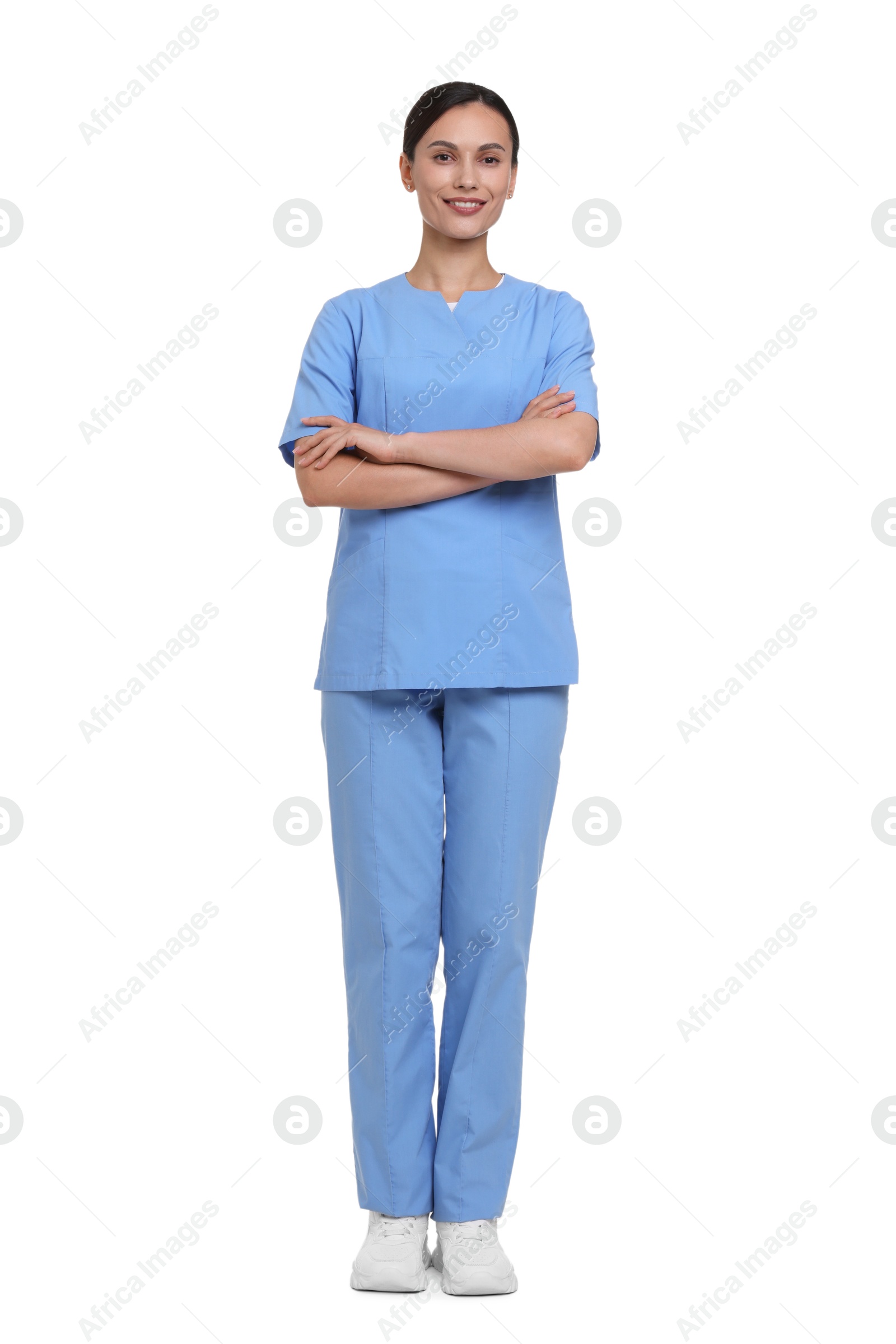 Smiling nurse in uniform with crossed arms on white background Photo of Smiling nurse in uniform with crossed arms on white background
