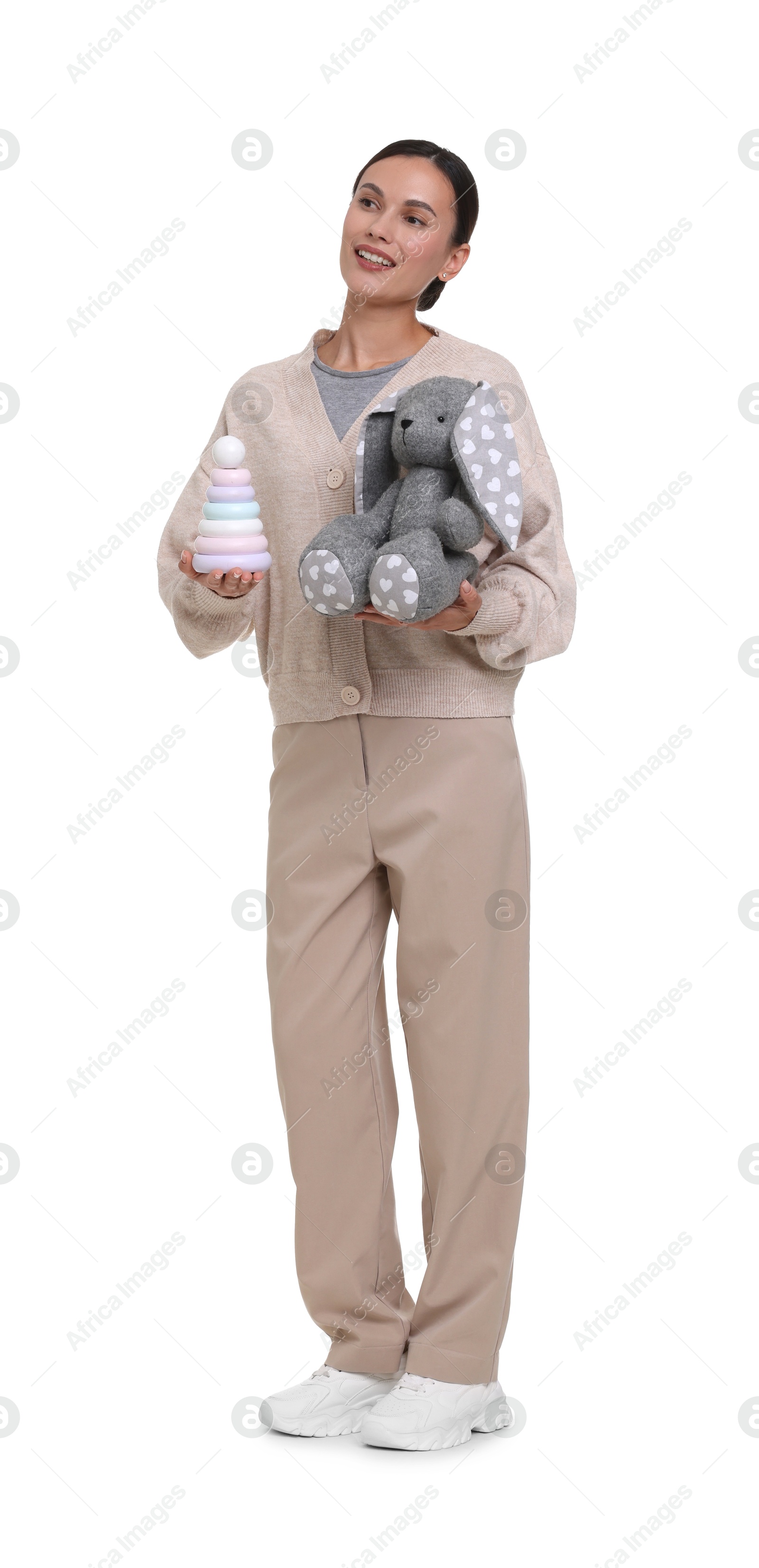 Smiling nursery teacher with toys on white background Photo of Smiling nursery teacher with toys on white background