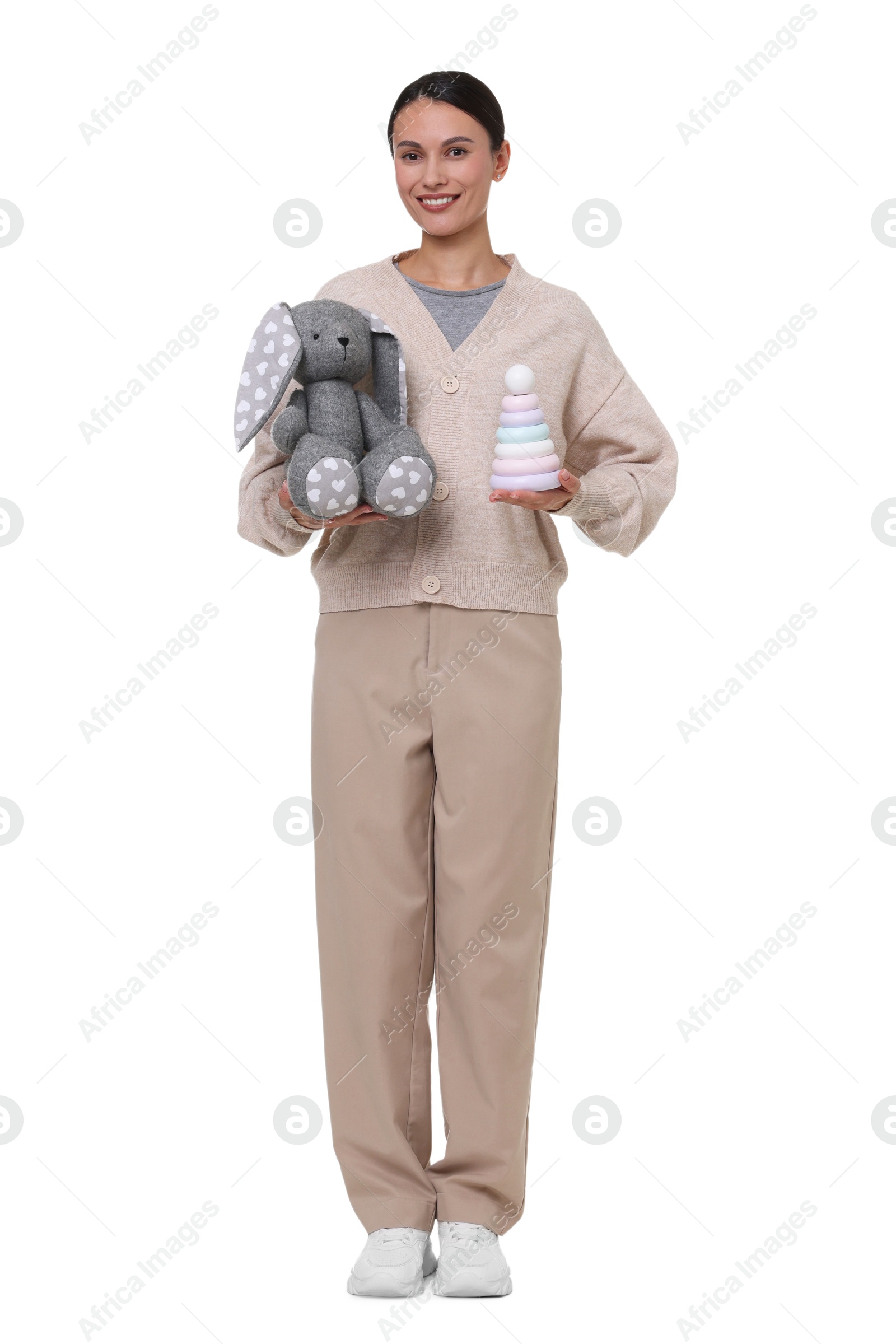Smiling nursery teacher with toys on white background Photo of Smiling nursery teacher with toys on white background