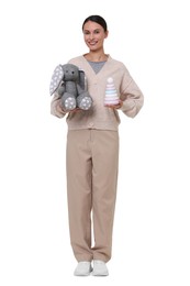 Photo of Smiling nursery teacher with toys on white background