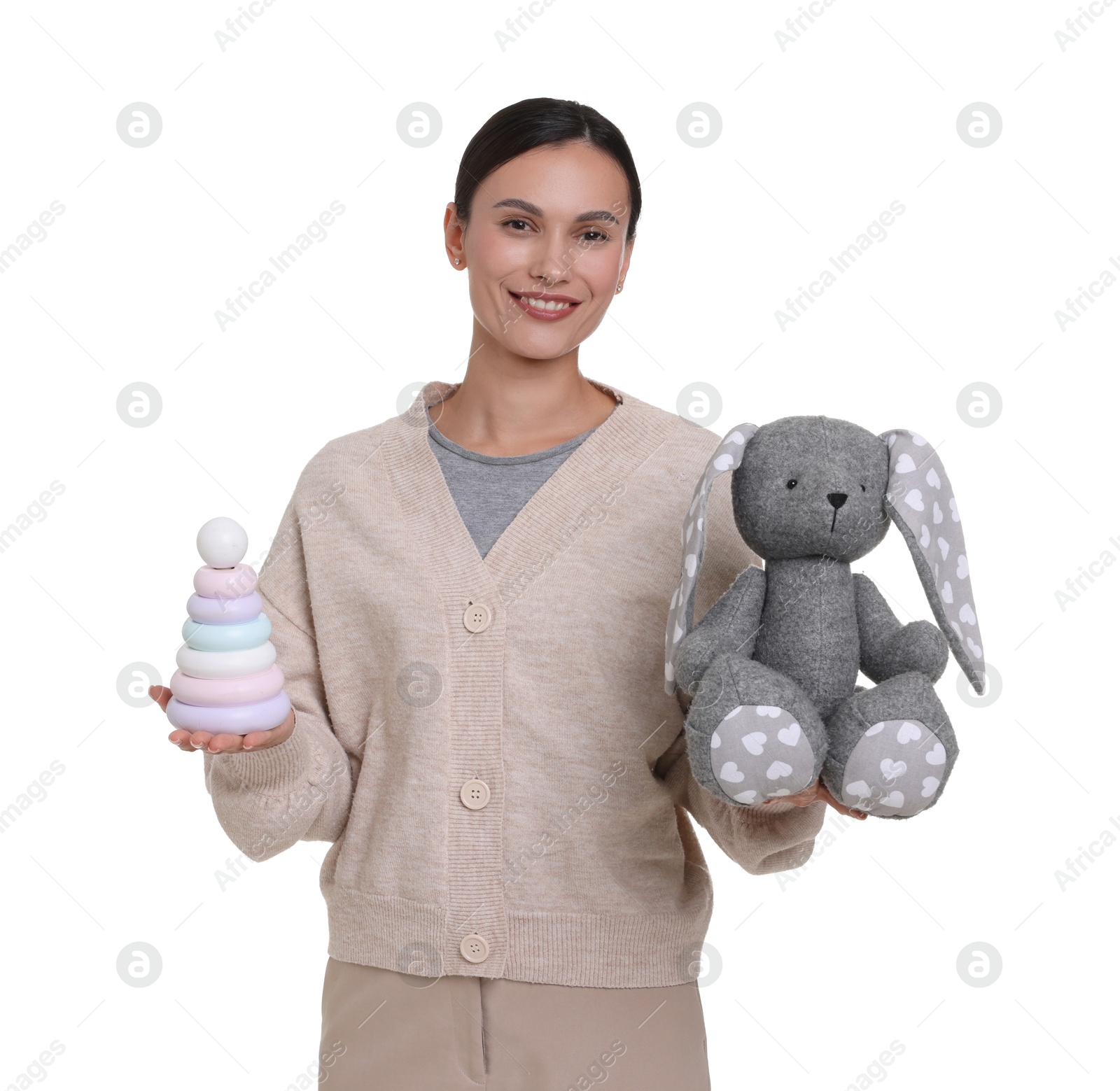 Smiling nursery teacher with toys on white background Photo of Smiling nursery teacher with toys on white background
