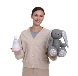 Photo of Smiling nursery teacher with toys on white background