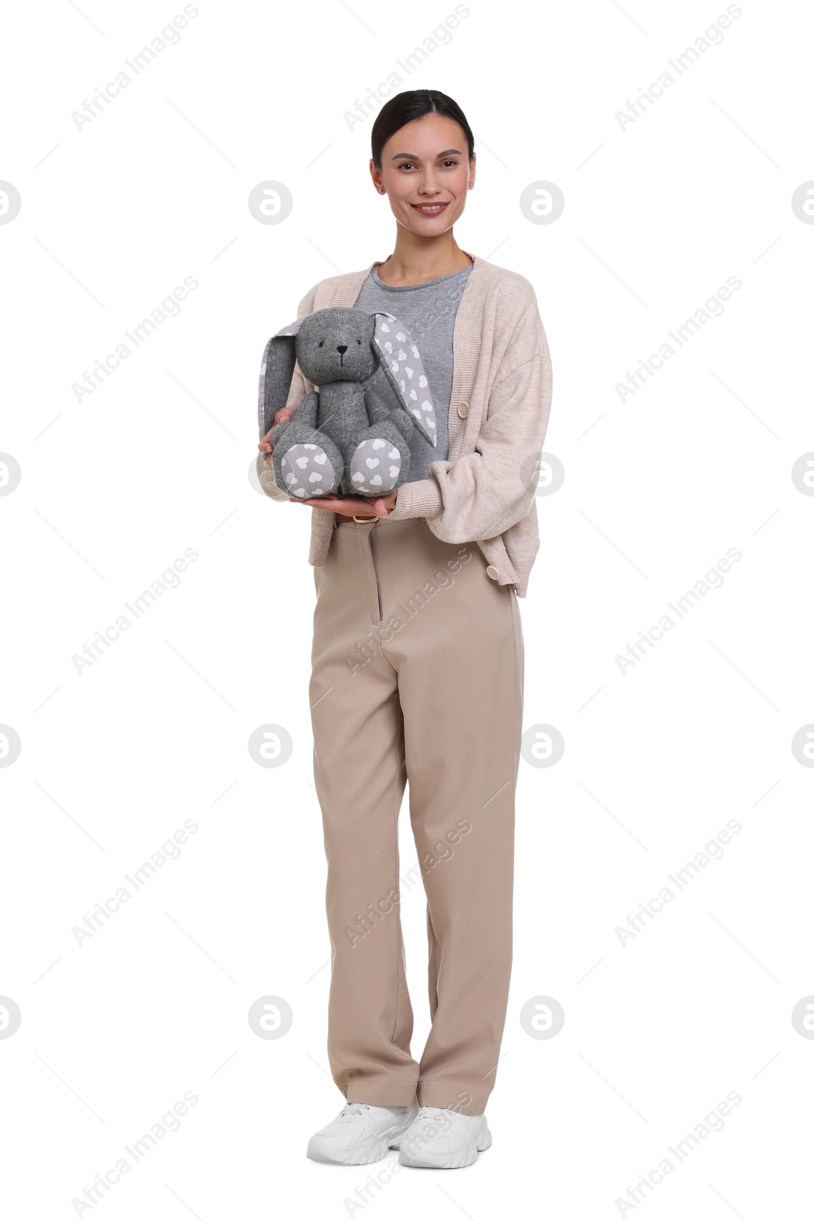Smiling nursery teacher with toy rabbit on white background Photo of Smiling nursery teacher with toy rabbit on white background