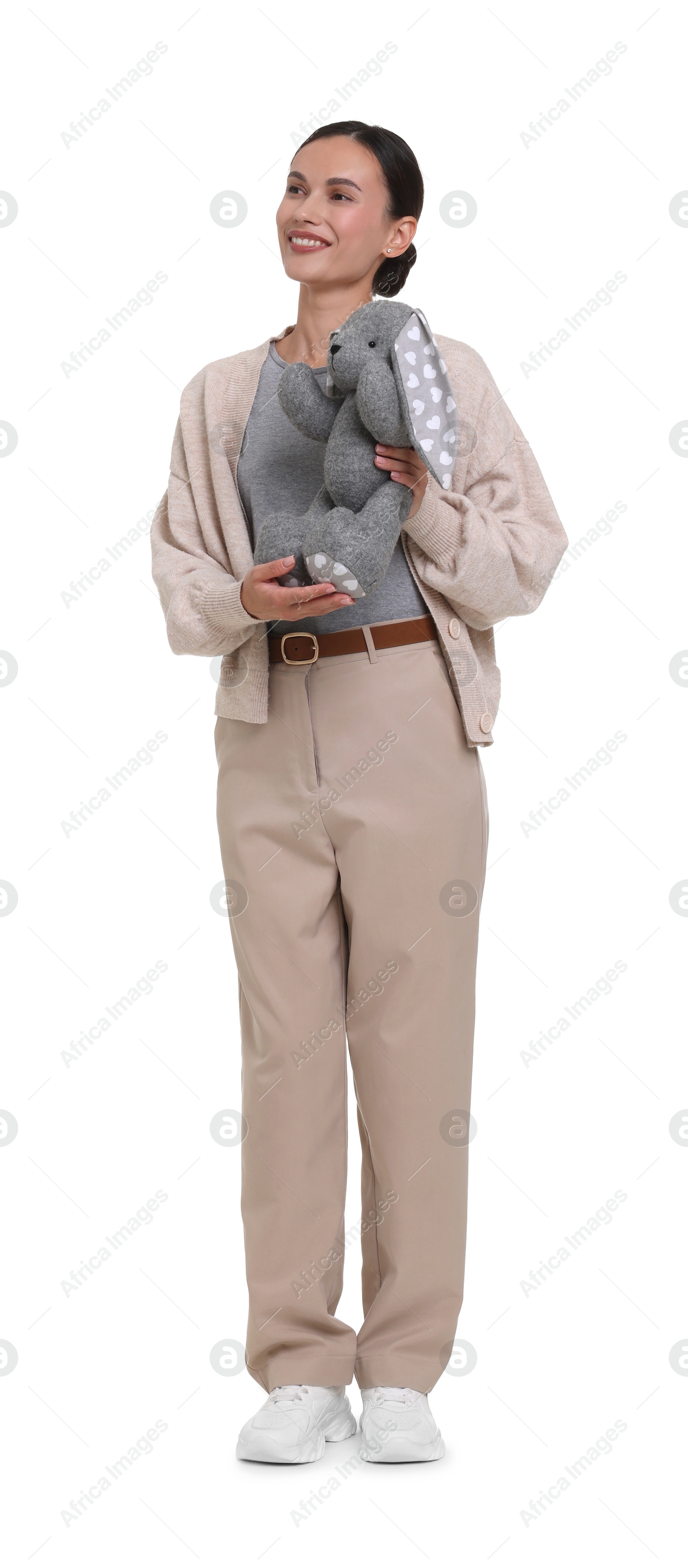 Smiling nursery teacher with toy rabbit on white background Photo of Smiling nursery teacher with toy rabbit on white background