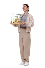Photo of Smiling nursery teacher with educational toy on white background