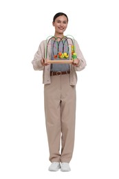 Photo of Smiling nursery teacher with educational toy on white background