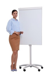 Photo of Smiling businesswoman near flip chart on white background. Space for text