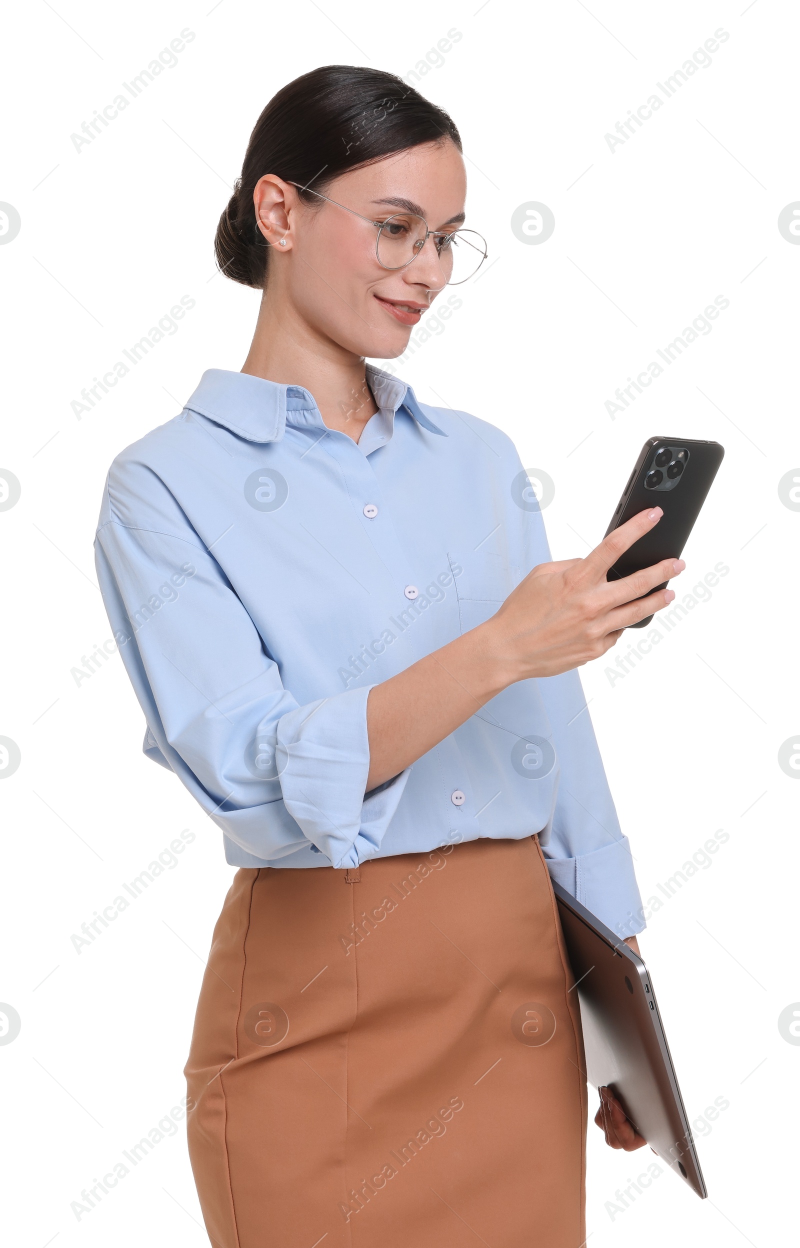 Smiling businesswoman in glasses with laptop using smartphone on white background Photo of Smiling businesswoman in glasses with laptop using smartphone on white background