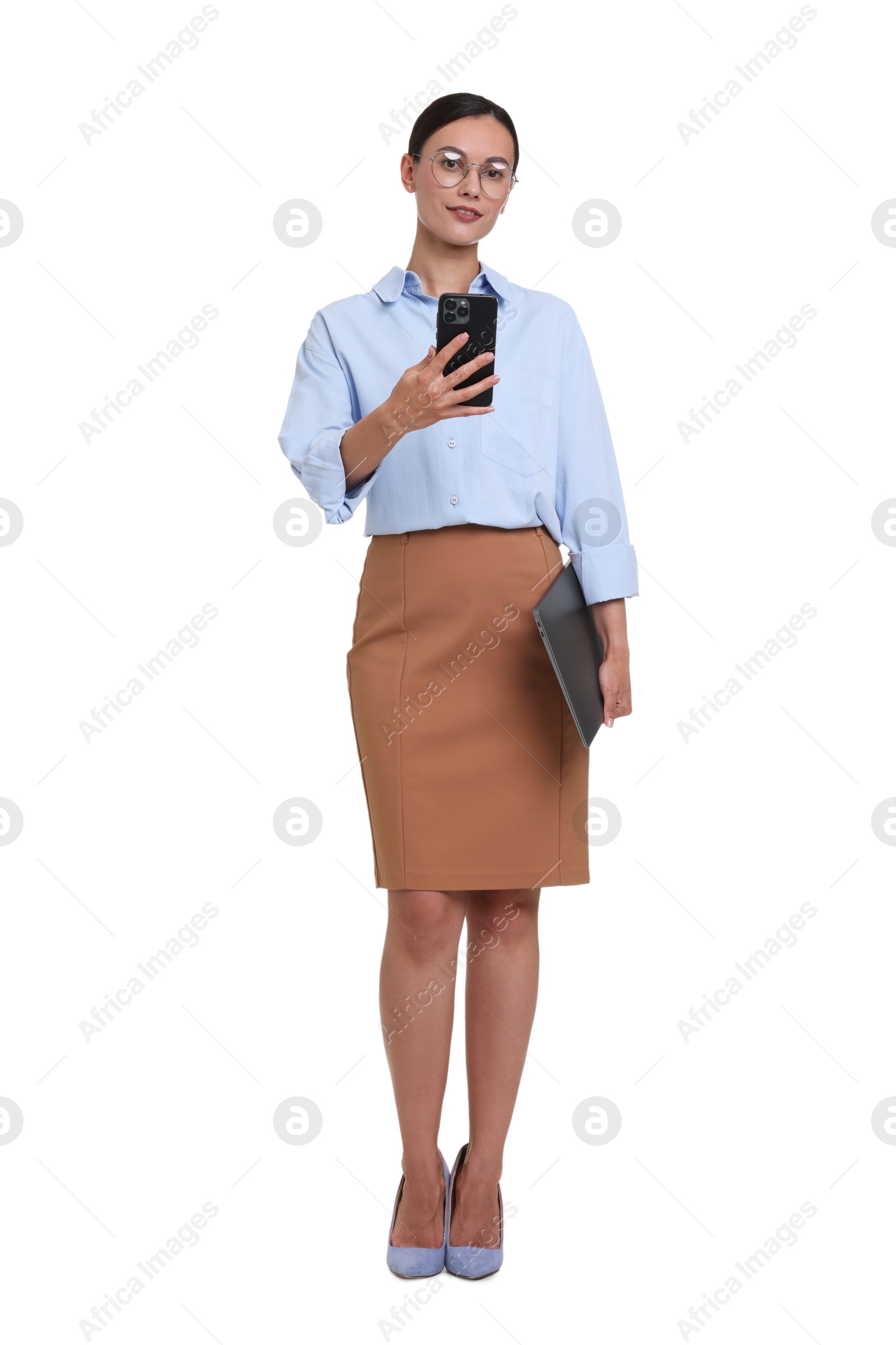 Businesswoman in glasses with laptop using smartphone on white background Photo of Businesswoman in glasses with laptop using smartphone on white background